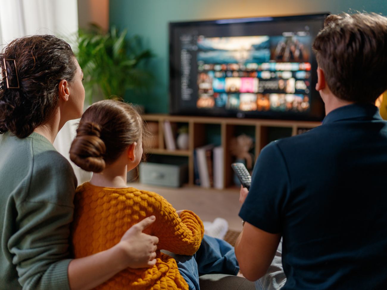 Family watching TV in their apartment