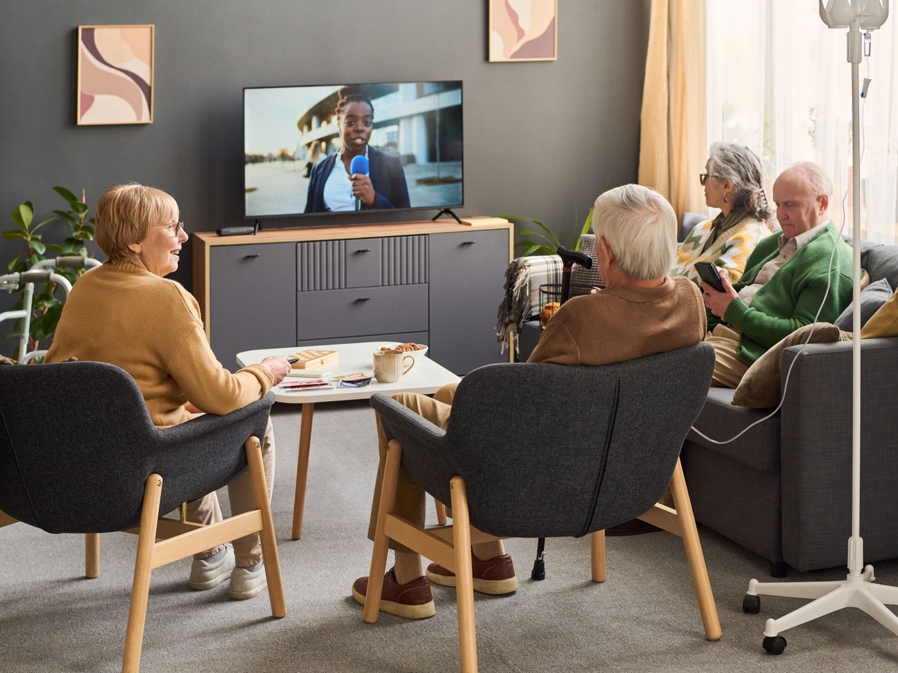 Residents watching the community channel in a lounge