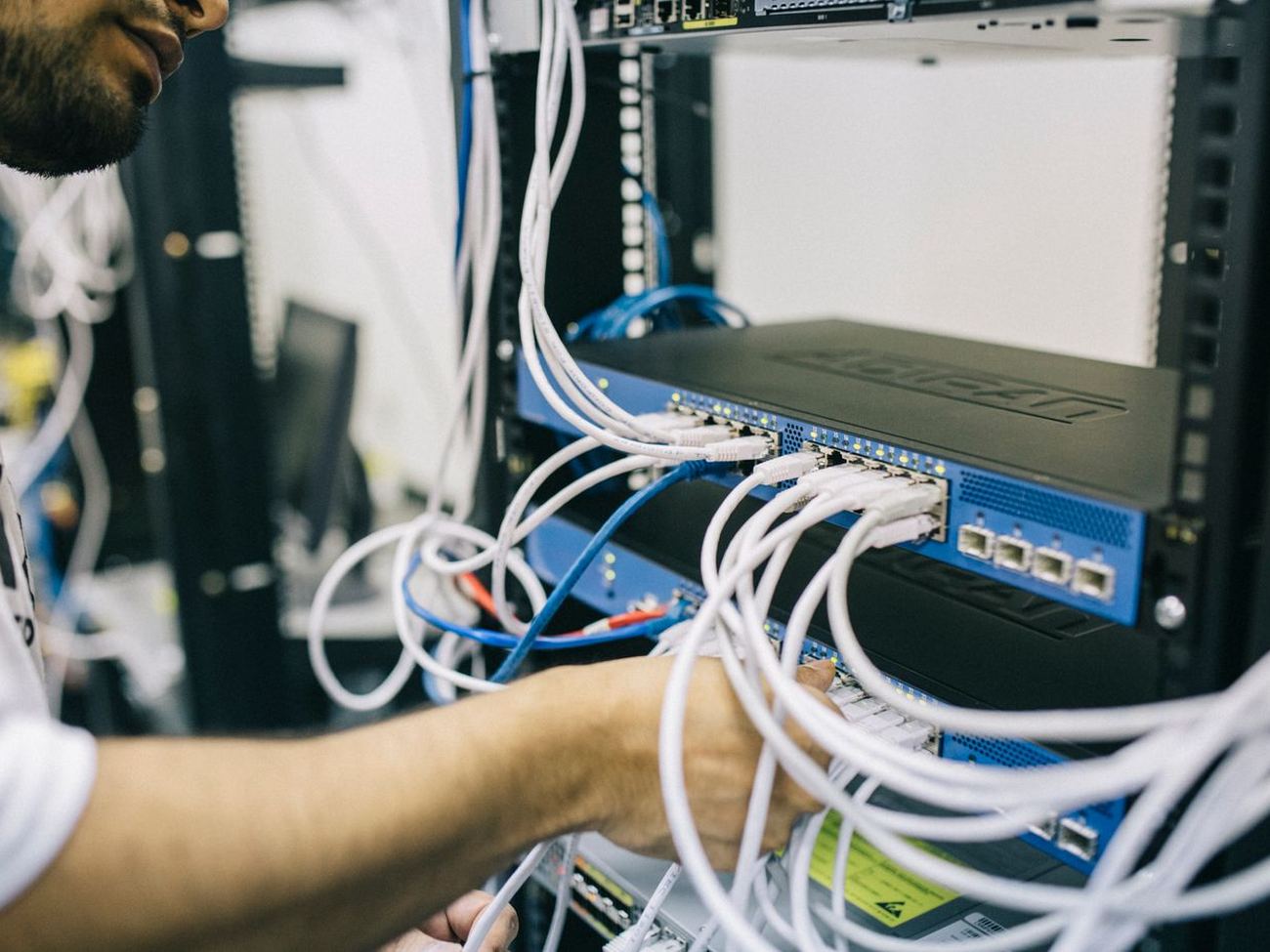 Empire technician wiring a network rack