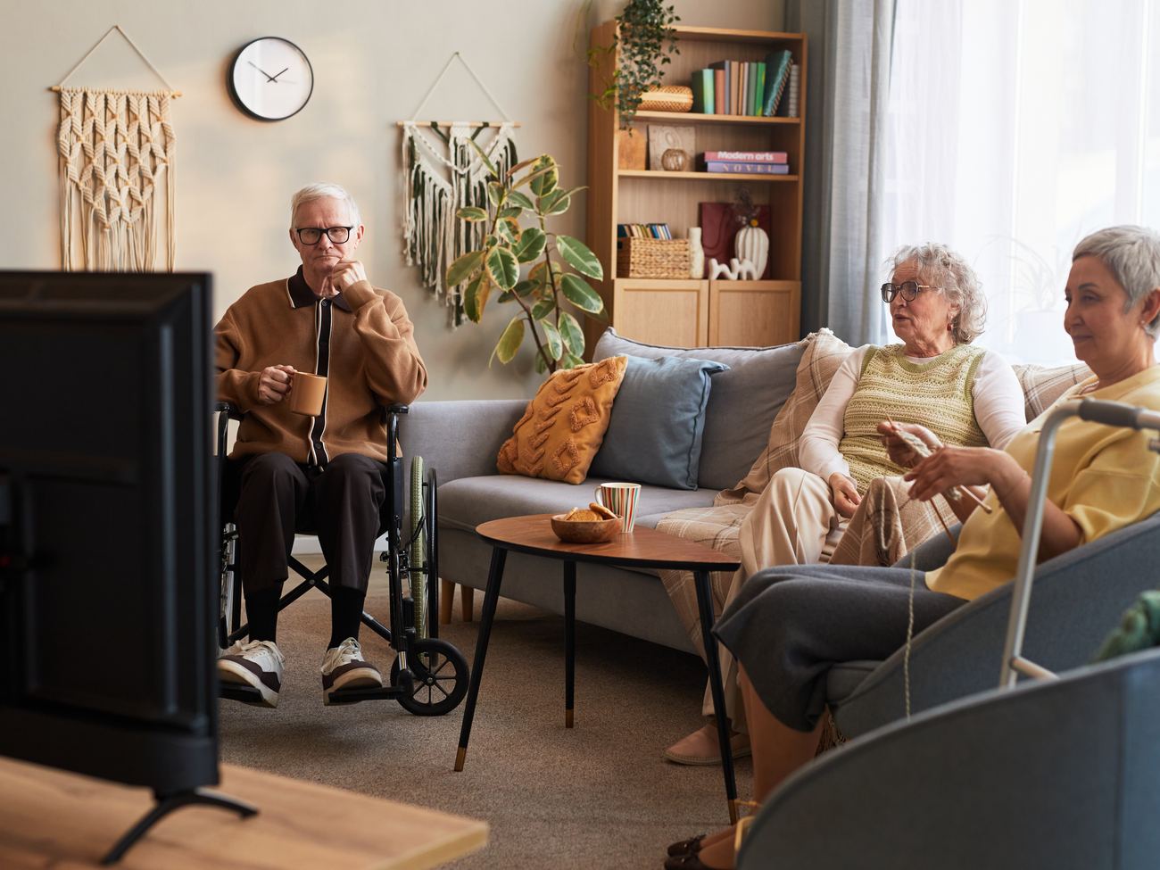 Residents watching television in a senior living lounge